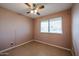 Bedroom with ceiling fan and tile floors at 12007 N Saint Annes Dr, Sun City, AZ 85351