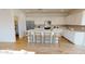 Modern kitchen with white cabinets, large island, and stainless steel appliances at 12539 W Parkway Ln, Avondale, AZ 85323