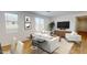 Spacious living room with light walls, hardwood floors, and comfortable seating at 12539 W Parkway Ln, Avondale, AZ 85323
