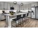 Modern kitchen with granite island, stainless steel appliances, and gray cabinets at 12630 W Parkway Ln, Avondale, AZ 85323