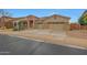 Charming home with a three car garage and a stone accent facade at 15333 W Sells Dr, Goodyear, AZ 85395