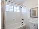 Clean bathroom with a bathtub, shower, and window at 15804 S 15Th Pl, Phoenix, AZ 85048