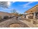Landscaped backyard with a patio, gravel, and mature plants at 15825 N 110Th Ave, Sun City, AZ 85351