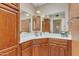 Bathroom with corner vanity, wood cabinets, and a shower at 15825 N 110Th Ave, Sun City, AZ 85351