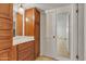 Bathroom with wood cabinets and a large mirror at 15825 N 110Th Ave, Sun City, AZ 85351