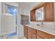 Bathroom with wood vanity and large window at 15825 N 110Th Ave, Sun City, AZ 85351