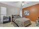 Bedroom with orange accent wall and ceiling fan at 15825 N 110Th Ave, Sun City, AZ 85351