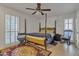Bedroom with a four poster bed and ceiling fan at 15825 N 110Th Ave, Sun City, AZ 85351