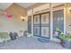 Front entry with decorative wrought-iron security door and potted plants at 15825 N 110Th Ave, Sun City, AZ 85351