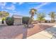 Single-story home with desert landscaping and a large palm tree in the front yard at 15825 N 110Th Ave, Sun City, AZ 85351