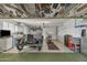 Garage with vintage car, motorcycle, and overhead storage at 15825 N 110Th Ave, Sun City, AZ 85351
