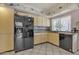 Kitchen features black appliances and yellow cabinets at 15825 N 110Th Ave, Sun City, AZ 85351