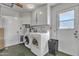 Laundry room with washer, dryer, and ample storage cabinets at 15825 N 110Th Ave, Sun City, AZ 85351