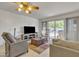 Living room with wood flooring, a rocking chair, and access to a patio at 15825 N 110Th Ave, Sun City, AZ 85351