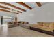 Spacious living room featuring a large sectional sofa, wood beams, and a chandelier at 15825 N 110Th Ave, Sun City, AZ 85351