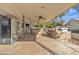 Covered patio with a ceiling fan, outdoor kitchen, and seating area at 15825 N 110Th Ave, Sun City, AZ 85351