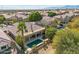 Aerial view of house, pool, and palm trees in desert setting at 1714 E Saltsage Dr, Phoenix, AZ 85048