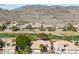 Aerial view of homes near a golf course and mountains at 1714 E Saltsage Dr, Phoenix, AZ 85048