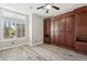 Spacious bedroom with wood built-in shelving and hardwood floors at 1714 E Saltsage Dr, Phoenix, AZ 85048