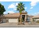 Single story house with tile roof, two car garage, and palm tree at 1714 E Saltsage Dr, Phoenix, AZ 85048
