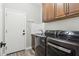Laundry room with washer, dryer, and built-in cabinets at 1714 E Saltsage Dr, Phoenix, AZ 85048