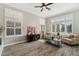 Living area with hardwood floors, plantation shutters, and comfy seating at 1714 E Saltsage Dr, Phoenix, AZ 85048