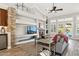Large living room with stone fireplace, built-in shelving, and hardwood floors at 1714 E Saltsage Dr, Phoenix, AZ 85048