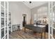 Home office with wood desk, hardwood floors, and built-in shelving at 1714 E Saltsage Dr, Phoenix, AZ 85048