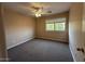 Well-lit bedroom featuring a ceiling fan and large window at 17322 W Carmen Dr, Surprise, AZ 85388