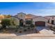 Single-story home with landscaped yard and two-car garage at 189 E Atacama Ln, Queen Creek, AZ 85140