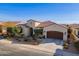 Single-story home with landscaped yard and two-car garage at 189 E Atacama Ln, Queen Creek, AZ 85140