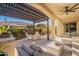 Covered patio with comfortable seating and fire pit at 189 E Atacama Ln, Queen Creek, AZ 85140