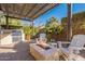 Relaxing backyard patio with fire pit, built-in grill, and pergola at 189 E Atacama Ln, Queen Creek, AZ 85140