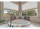 Relaxing bathroom with a corner soaking tub and large windows at 189 E Atacama Ln, Queen Creek, AZ 85140