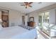 Spacious bedroom with plush bedding and access to a private patio at 189 E Atacama Ln, Queen Creek, AZ 85140