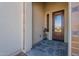 Front entry with decorative tile and a glass-paned door at 189 E Atacama Ln, Queen Creek, AZ 85140