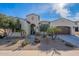 Single-story home with desert landscaping and a two-car garage at 189 E Atacama Ln, Queen Creek, AZ 85140