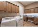 Laundry room with built-in desk and storage at 189 E Atacama Ln, Queen Creek, AZ 85140