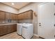 Laundry room with washer, dryer and ample cabinetry at 189 E Atacama Ln, Queen Creek, AZ 85140