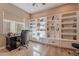 Home office with built-in shelving and a workspace at 189 E Atacama Ln, Queen Creek, AZ 85140