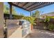 Built-in outdoor kitchen with stainless steel grill at 189 E Atacama Ln, Queen Creek, AZ 85140