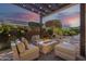 Cozy patio with a fire pit and comfortable seating, perfect for relaxing evenings under the pergola lights at 189 E Atacama Ln, Queen Creek, AZ 85140