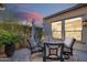Outdoor patio with seating around a table, enclosed by a fence and lush greenery, creating a private retreat at 189 E Atacama Ln, Queen Creek, AZ 85140