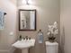 Elegant powder room with pedestal sink and decorative accents at 189 E Atacama Ln, Queen Creek, AZ 85140