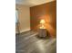 This bedroom features wood-look floors and a small table with a lamp at 1920 W Lindner W Ave # 108, Mesa, AZ 85202