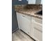 Kitchen features white dishwasher and granite countertops at 1920 W Lindner W Ave # 108, Mesa, AZ 85202