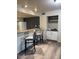 Eat-in kitchen features bar seating, cabinet storage, and wood flooring at 1920 W Lindner W Ave # 108, Mesa, AZ 85202
