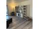 Cozy living room with grey wood-look floors, custom built-ins, and neutral decor at 1920 W Lindner W Ave # 108, Mesa, AZ 85202