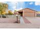 Tan brick house with a two-car garage and a white picket fence at 2002 N Central Dr, Chandler, AZ 85224