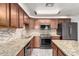 Granite countertops and stainless steel appliances feature in this updated kitchen at 2002 N Central Dr, Chandler, AZ 85224